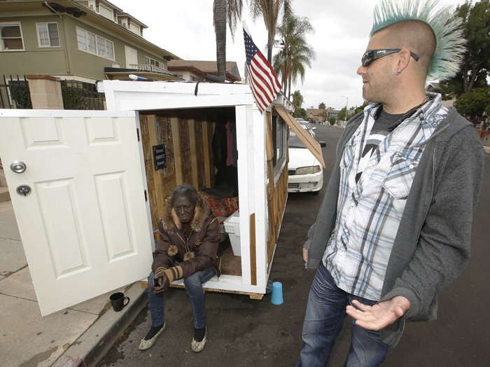 Los Angeles resident Elvis Summers poses with his tiny house on wheels he built. Summers never thought more than 5.6 million people would watch a YouTube video of him constructing the 8-foot-long house, which is small enough to fit in a parking space.